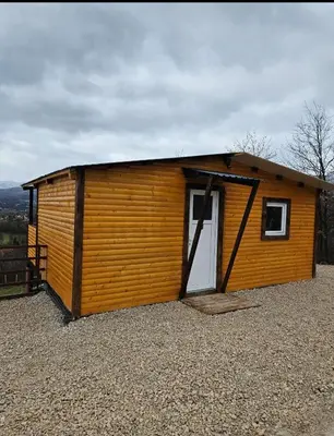 a small wooden shed with a door on a hill at blanca 6 in Nova Bila