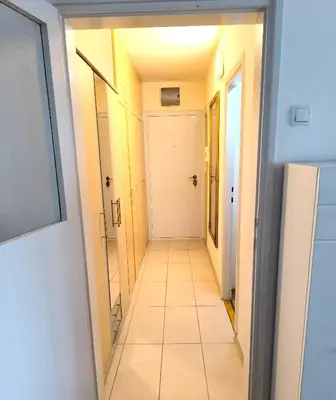 a long hallway with a white tile floor at Apartment Sneki Banja Luka in Banja Luka