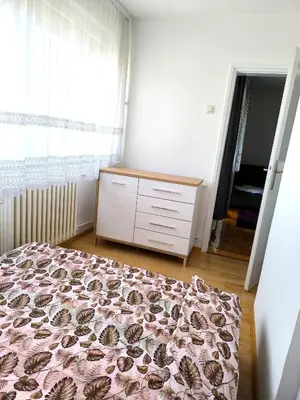 a bedroom with a bed and a dresser and a window at Apartment Sneki Banja Luka in Banja Luka