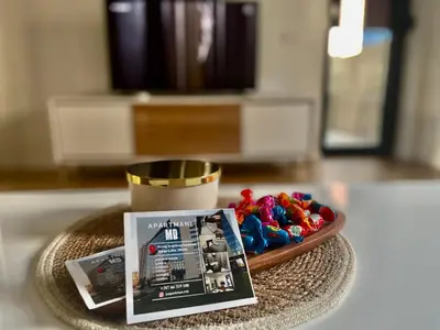 a plate with a magazine and some toys on a table at Apartman MB in Banja Luka