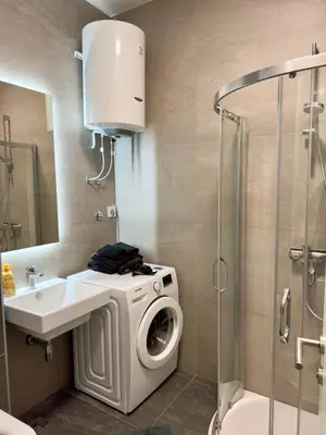 a bathroom with a washing machine and a sink at Apartman MB in Banja Luka