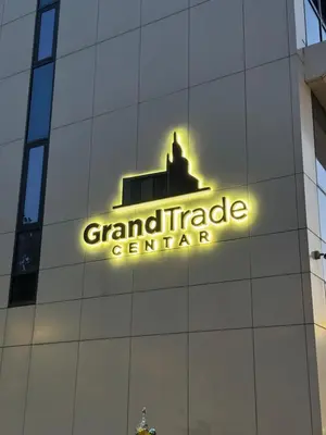 a neon sign on the side of a building at Apartman MB in Banja Luka