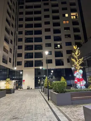 a christmas tree in a courtyard in front of a building at Apartman MB in Banja Luka
