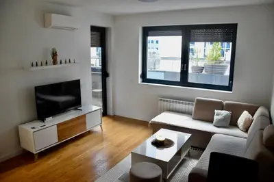 a living room with a couch and a flat screen tv at Apartman MB in Banja Luka