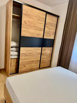 a bedroom with a bed and a closet at Apartman Dublin in Banja Luka