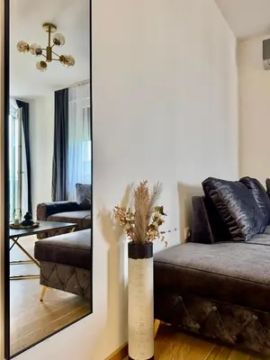 a living room with a couch and a mirror at Apartman Dublin in Banja Luka