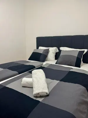 a room with two beds with pillows on it at Apartman Dublin in Banja Luka