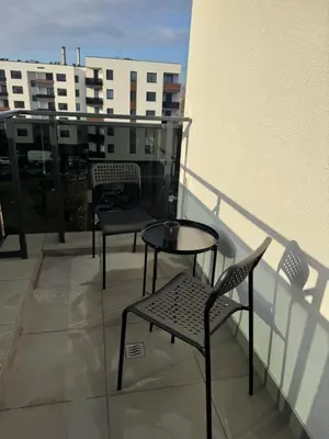a balcony with two chairs and a table on a building at Apartman Dublin in Banja Luka