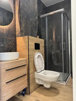 a bathroom with a toilet and a shower and a sink at Apartman Dublin in Banja Luka