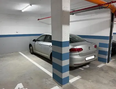 a parking garage with a car parked in it at Apartman Dublin in Banja Luka