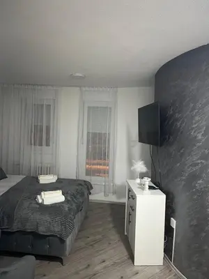 a bedroom with a bed and a tv in it at Apartman Latea in Banja Luka