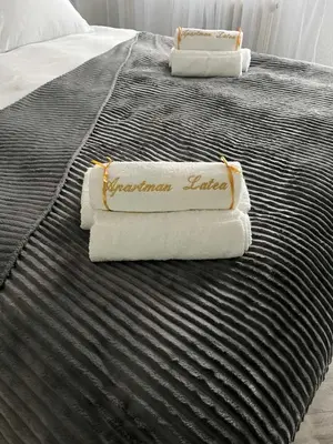 a bed with two towels on top of it at Apartman Latea in Banja Luka