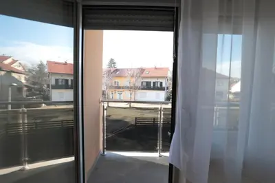 an open window with a view of a building at Apartman Dentalux 1 in Banja Luka