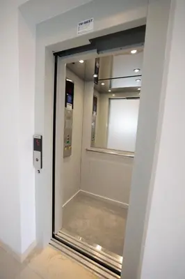 a glass door in a room with a window at Apartman Dentalux 1 in Banja Luka