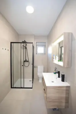 a bathroom with a shower and a toilet and a sink at Apartman Dentalux 2 in Banja Luka