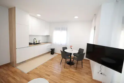 a kitchen and dining room with a table and chairs at Apartman Dentalux 2 in Banja Luka