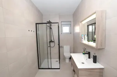 a bathroom with a shower and a toilet and a sink at Apartman Dentalux 2 in Banja Luka