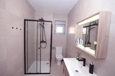 a bathroom with a shower and a toilet and a sink at Apartman Dentalux 2 in Banja Luka