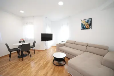 a living room with a couch and a table at Apartman Dentalux 2 in Banja Luka