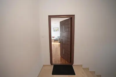 a door leading into a room with a hallway at Apartman Dentalux 3 in Banja Luka