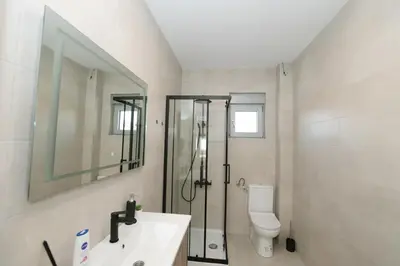 a bathroom with a shower and a sink and a toilet at Apartman Dentalux 3 in Banja Luka