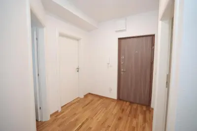 an empty room with a door and a wooden floor at Apartman Dentalux 4 in Banja Luka