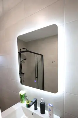 a bathroom with a large mirror over a sink at Apartman Dentalux 4 in Banja Luka