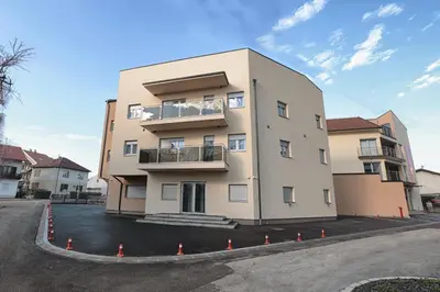 a large building in the middle of a parking lot at Apartman Dentalux 4 in Banja Luka