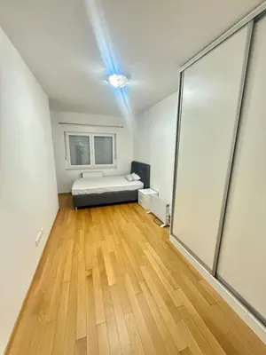 a room with a bed and a wooden floor at Apartman Dentalux 5 in Banja Luka
