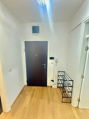 an empty room with a black door and a wooden floor at Apartman Dentalux 5 in Banja Luka