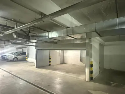an empty parking garage with a car parked in it at Apartman Dentalux 5 in Banja Luka