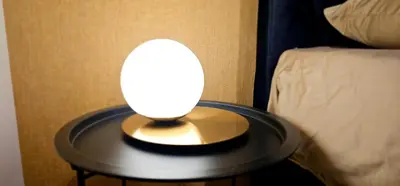 a lamp on a table next to a bed at Aleja Dua in Banja Luka