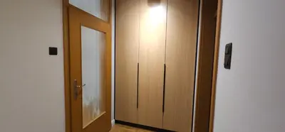 a hallway with a wooden door and a room with a floor at Aleja Dua in Banja Luka