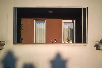 a mirror on the side of a building with a window at Aleja Dua in Banja Luka