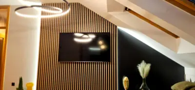 a black and white wall with a mirror in a room at Aleja Dua in Banja Luka