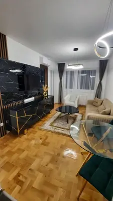 a living room with a couch and a table at Zlatni San apartman 1 in Banja Luka
