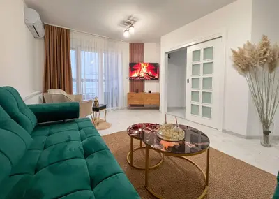 a living room with a green couch and a table at Apartman Royal 1 in Doboj
