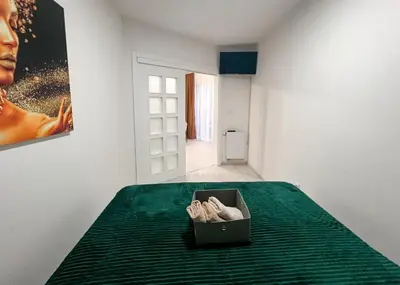 a box of shoes sitting on top of a bed at Apartman Royal 1 in Doboj