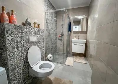 a bathroom with a toilet and a glass shower at Apartman Royal 1 in Doboj