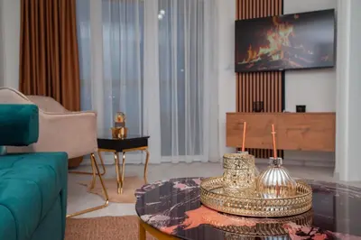 a living room with a couch and a tv at Apartman Royal 1 in Doboj