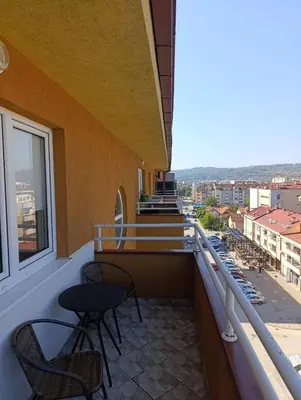 a balcony with chairs and a view of a city at Apartman AsHome in Banja Luka