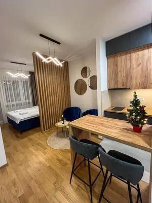 a kitchen and living room with a table and chairs at Stan na dan Libero Apartman in Banja Luka