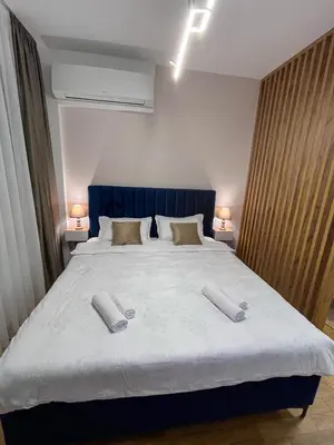 a bedroom with a large bed with two pillows on it at Stan na dan Libero Apartman in Banja Luka