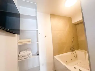 a small bathroom with a tub and a sink at KING - Apartment & SPA in Banja Luka