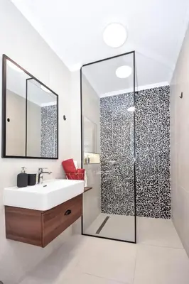 a bathroom with a white sink and a shower at Hostel Havana in Banja Luka