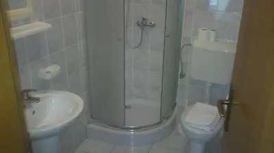 a bathroom with a shower and a toilet and a sink at Hostel Havana in Banja Luka