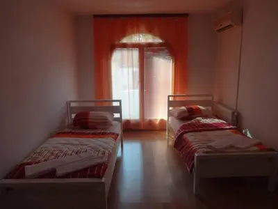 two beds in a room with a window at Hostel Havana in Banja Luka