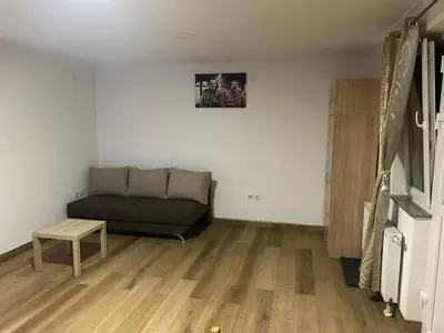 a living room with a couch and a table at Studio apartman Banja Luka in Železnička Stanica Banja Luka Predgrađe