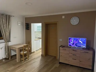 a living room with a television on top of a dresser at Studio apartman Banja Luka in Železnička Stanica Banja Luka Predgrađe