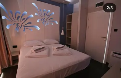 a bedroom with a bed with towels on it at Apartmani Prag in Banja Luka